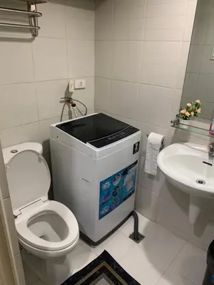 a bathroom with a toilet and a sink at MOA Staycation - by Marites in Manila