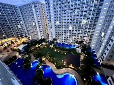 an overhead view of a large building with a swimming pool at Cozy Luxe Stay 55 inch 4k Ultra TV and Amenity View in Manila