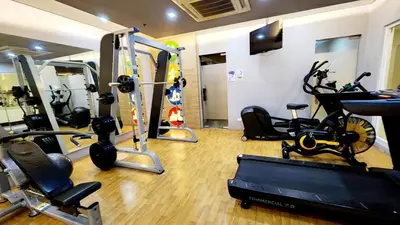 a gym with cardio equipment and bikes in a room at Casa Antonio at 8L Two Palm Tree Beside NAIA3 in Manila