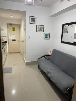 a living room with a couch and a hallway at Joyce Condo unit Sea Residences in Manila