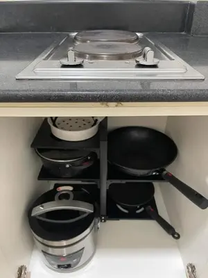 a kitchen with a stove and some pots and pans at Joyce Condo unit Sea Residences in Manila