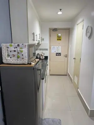a kitchen with a black and white counter top at Joyce Condo unit Sea Residences in Manila