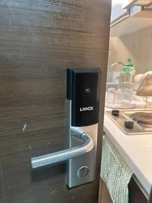 a lock on a kitchen door with a sink at Air Residences 3 by AG in Manila