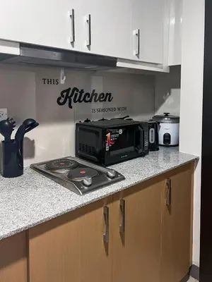 a kitchen with a microwave on a counter top at Modern 1BR BGC Uptown View in Manila