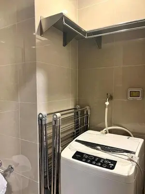 a washing machine in a bathroom with a ceiling at Modern 1BR BGC Uptown View in Manila