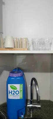 a blue container sitting next to a kitchen sink at Rqui Rooms Near Airport in Manila