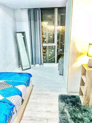 a bedroom with a bed and a large window at St Tropez PH 07 in Manila