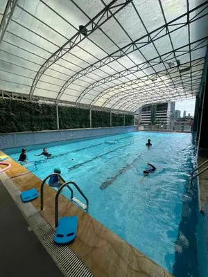 a group of people swimming in a swimming pool at A venue Residences 1801 in Manila
