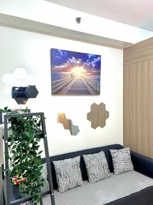 a living room with a couch and a painting on the wall at 1 Bedroom Condo at Shore 2 Near Airport with Balcony & Pool View in Manila