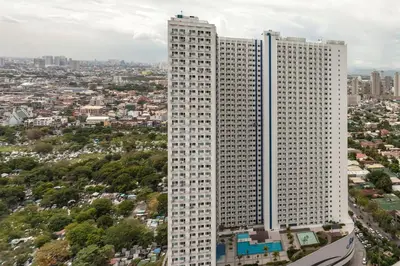 an overhead view of a tall white building at Cozy 1BR Condo at Jazz Residences in Manila