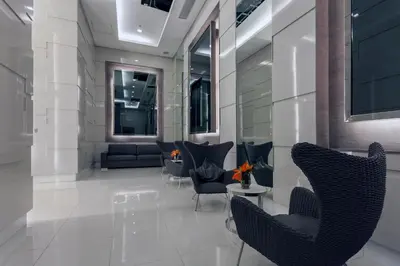 a lobby with chairs and couches in a building at Fully Furnished 1BR Condo at Jazz Residences in Manila