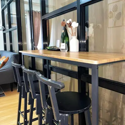 a table with two chairs and a bottle of wine at Elim Escape Staycation in Trece Martires