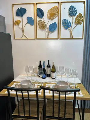 a table with wine glasses and wine bottles at Elim Escape Staycation in Trece Martires