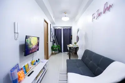 a living room with a couch and a table at Elegant yet Affordable condo in Pasay in Manila