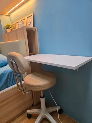 a desk with a chair and a white table at Cozy place near pavilion mall and Sm starosa in Biñan