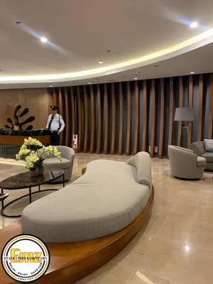 a man standing in a room with a bed at EMZ SHORE2 Staycation 16 in Manila