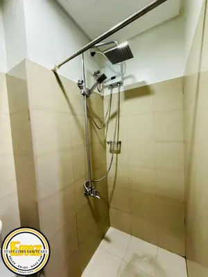 a shower with a shower head in a bathroom at EMZ SHORE2 Staycation 16 in Manila