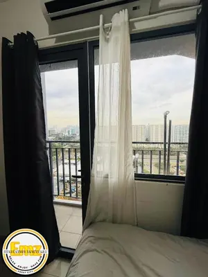 a bedroom with a bed and a window with a view at EMZ SHORE2 Staycation 16 in Manila