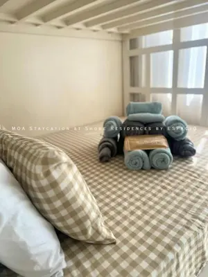 a bedroom with a bed with a toy train on it at Ezpacio in Manila