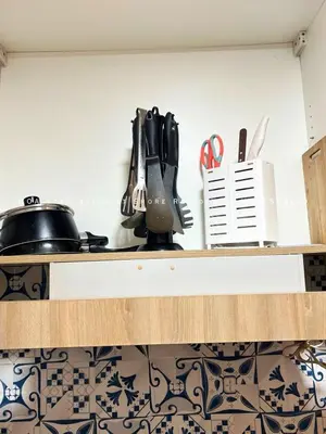 a kitchen counter with a mixer on a shelf at Ezpacio in Manila