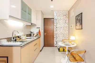 a kitchen with a sink and a table with chairs at Roam & Rest Staycation near NAIA Manila Airport and free WiFi in Manila
