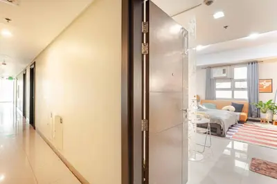 a hallway with a glass door leading to a living room at Roam & Rest Staycation near NAIA Manila Airport and free WiFi in Manila