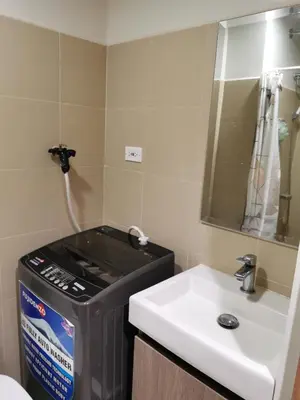 a bathroom with a sink and a mirror at Mall of Asia shore 3 condotel in Manila