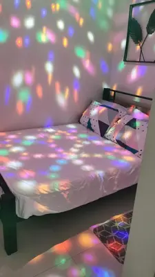 a bedroom with a bed with lights on it at Mao condotel shore 3 Pasay in Manila