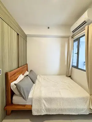 a bedroom with a bed and a window at Fame Residences 1br unit by LaBelle in Manila