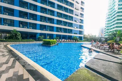 a large swimming pool in front of a building at Makati Bliss Designer Stay Pool gym park Net300 makati 1767 in Manila