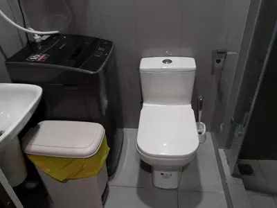 a bathroom with a white toilet and a sink at Makati Bliss Designer Stay Pool gym park Net300 makati 1767 in Manila