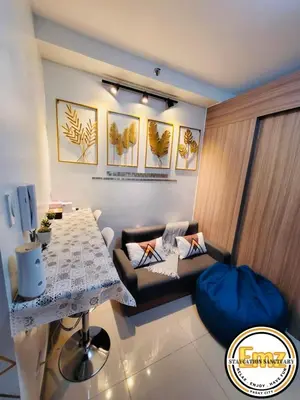 a living room with a table and a couch at EMZ SHORE2 Staycation 18 in Manila