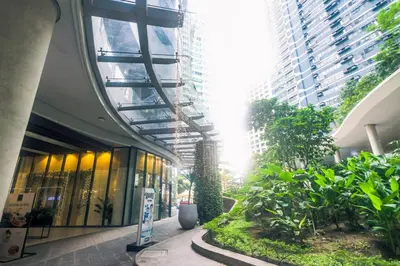 a building with a hallway with plants and buildings at Metro Paradise 1BR Comfort Makati swim gym park 300MB 2320 in Manila