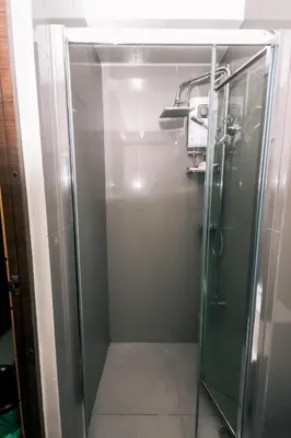 a shower with a glass door in a bathroom at Metro Paradise 1BR Comfort Makati swim gym park 300MB 2320 in Manila