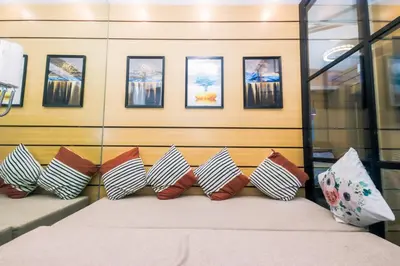 a room with a bed with a bunch of pillows at Metro Paradise 1BR Comfort Makati swim gym park 300MB 2320 in Manila