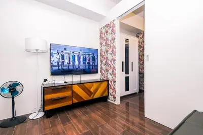 a living room with a flat screen tv on a wall at Suite Escape Luxe 1BR Makati condo Getaway Gym Swim Swim 2946 Fast MB in Manila