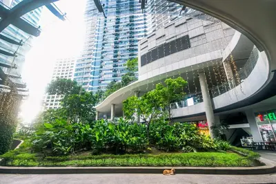 a large building with a garden in front of it at Urban Luxe 1BR Makati central gym swim Park Fast Internet MB 3301 in Manila