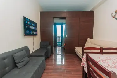 a living room with a couch and a bed at Urban Luxe 1BR Makati central gym swim Park Fast Internet MB 3301 in Manila