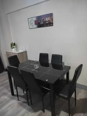 a black table with black chairs in a room at LDN Pinecrest Two-room Suite in Manila