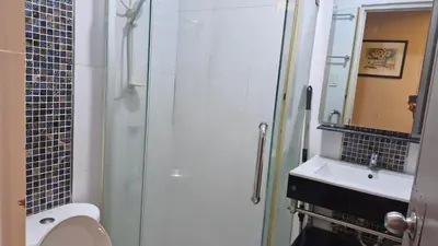 a bathroom with a shower and a toilet and a sink at MEZZA TOWER 2 SMARTTV 43inch in Manila