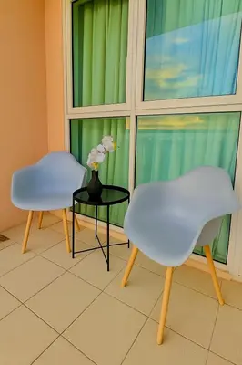 two chairs and a table in front of a window at Condo Venice Luxury Residences Grand canal View in Manila