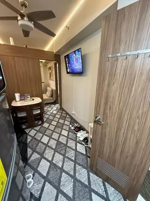 a room with a door and a tv on the wall at Fred Erick Staycation in Manila