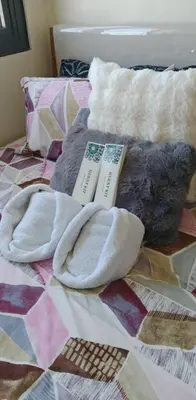 a bed with two towels and two books on it at Fred Erick Staycation in Manila
