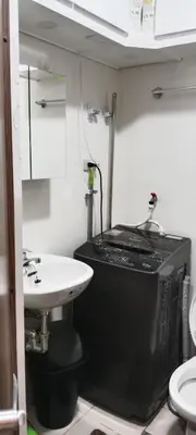 a small bathroom with a sink and a toilet at Fred Erick Staycation in Manila