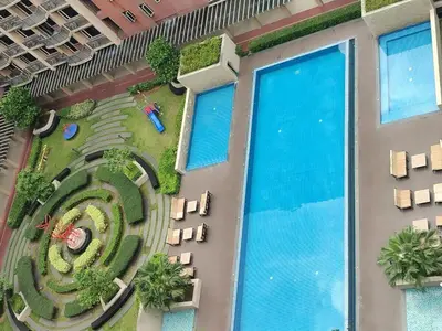an overhead view of a building with a swimming pool at Facing Pool w Balcony MOA BP1741 in Manila