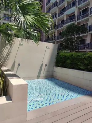 a swimming pool in front of a building at Facing Pool w Balcony MOA BP1741 in Manila