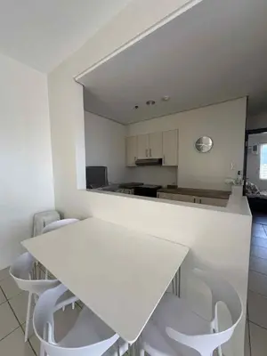 a white table and white chairs in a kitchen at East Bay Residences Condo Unit in Muntinlupa in Manila