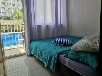 a bedroom with a bed and a window with a view at Staycation in Alabang Branch B in Manila