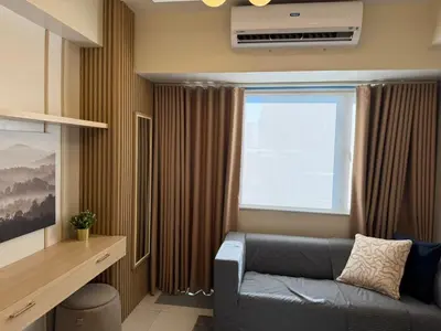 a living room with a couch and a window at Shore 3 Residence Aesthetic 1 BR in Manila