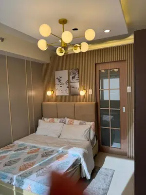 a bedroom with a bed and a ceiling fan at Shore 3 Residence Aesthetic 1 BR in Manila